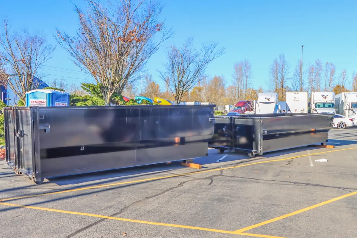 Professional dumpster rental service with roll-off container on residential driveway in Kings Point